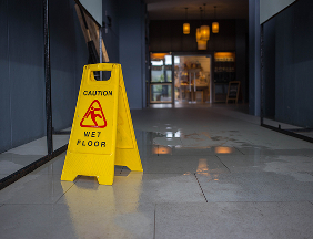 caution wet floor sign in dim hallway